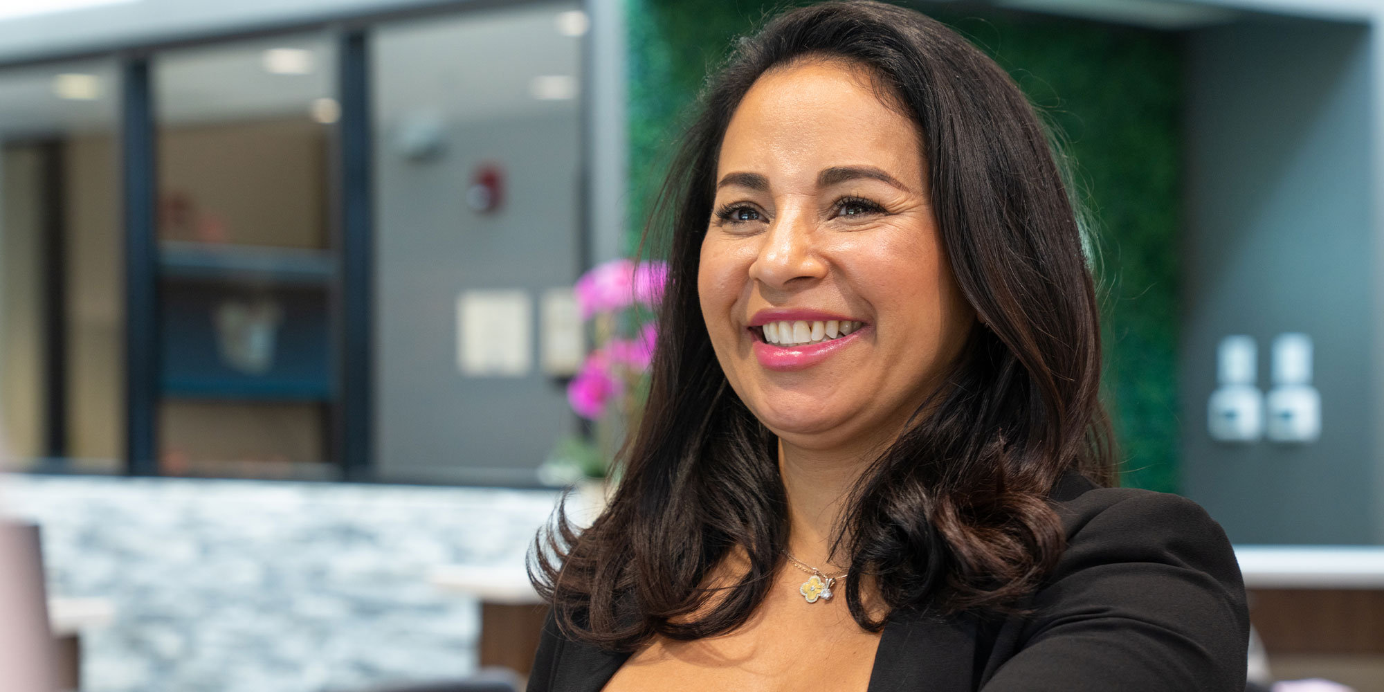 staff member helping patient at the front desk of the dental practice